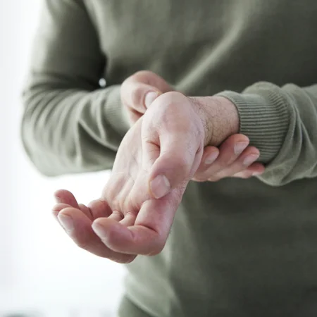 A person holding their wrist in pain