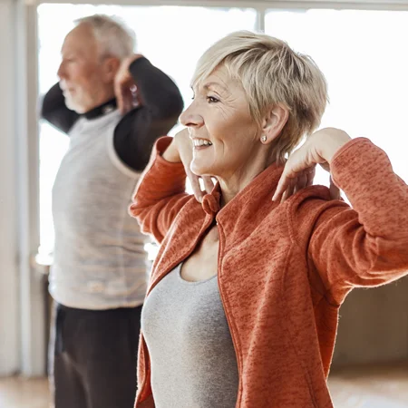 A middle-aged couple doing strengthening and corrective exercises